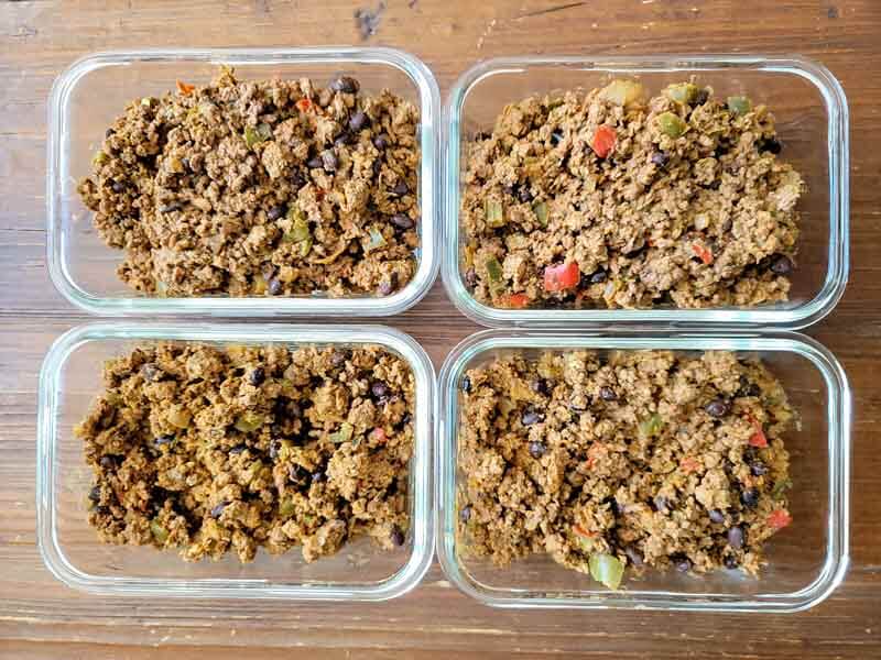 Batch cooked taco meat in glass airtight containers.