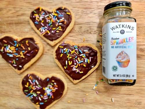 freshly made allergy-friendly sugar cookies frosted and covered with dye-free sprinkles