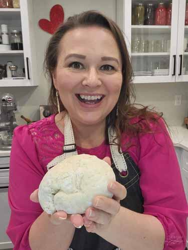 Amy holding a fresh ball of pizza dough