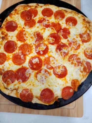 homemade gluten-free pizza, with cheese and pepperoni