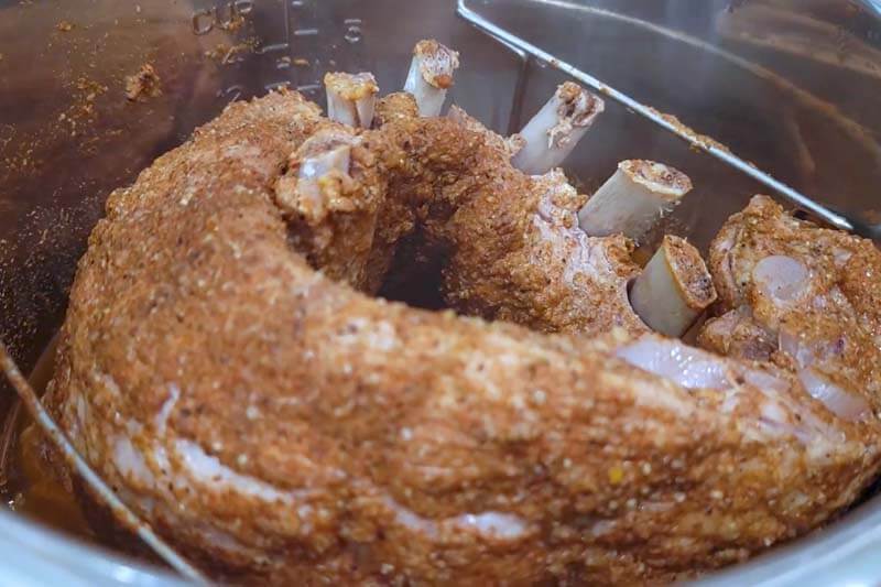 rack of pork spare ribs rolled and standing in an Instant Pot read to be cooked