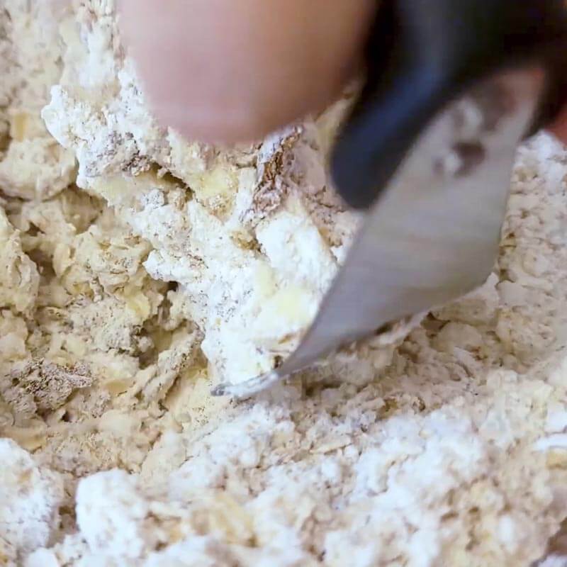 close up of pastry blender mixing up a fruit crisp topping