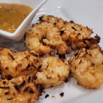 coconut coated shrimp cooked in an air fryer until golden brown